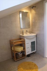 a bathroom with a sink and a mirror at Apartments Maričević in Korčula