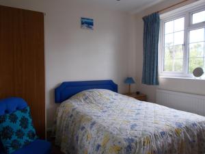 A bed or beds in a room at Arden Lodge