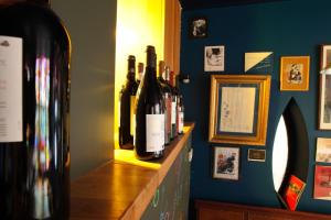 un montón de botellas de vino sentadas en un estante en Hotel O Mal Aime en Stavelot