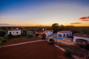 an aerial view of a house with a sunset in the background at Finca Las Tortugas in Campos