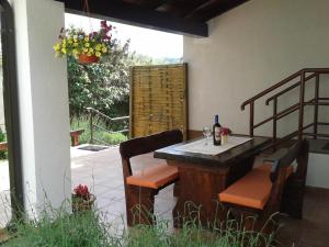 a patio table with chairs and a bottle of wine at Apartments Radović in Labin