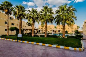 un complejo con palmeras y piscina en Boudl Al Malaz, en Riad