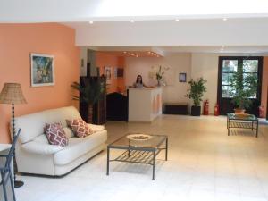 a living room with a couch and a table at Annaliza Apartments in Ipsos