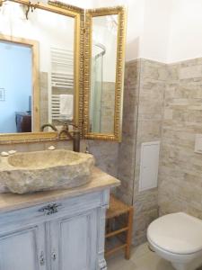 a bathroom with a sink and a toilet and a mirror at Wohnen auf dem Wallwitzhof in Lutherstadt Wittenberg