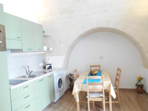 a kitchen with a table and a sink at Il Trifoglio in Matera