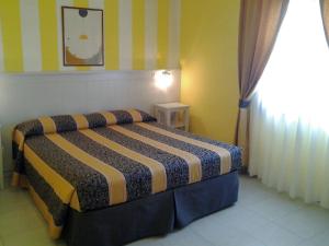 a bedroom with a bed in a room at Hotel Su Giudeu in Chia