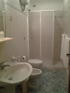 a bathroom with a toilet and a sink and a shower at Hotel Su Giudeu in Chia