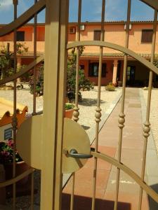 a spiral staircase with a building in the background at Hotel Su Giudeu in Chia