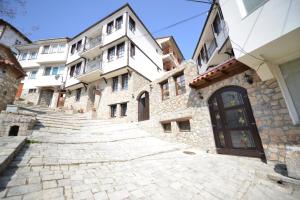 a stone building with stairs in front of a building at Villa & Winery Mal Sveti Kliment in Ohrid