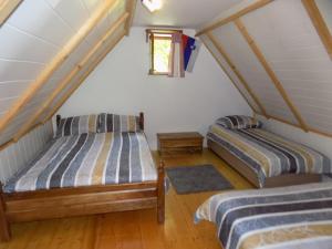 a bedroom with two beds in a attic at Holiday Home Na planini in Tolmin