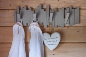 un par de calcetines colgando de una pared con un corazón en Kaldá Lyngholt Holiday Homes, en Egilsstadir