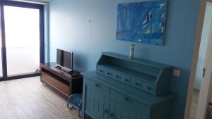 a living room with a dresser and a tv at Blue Anchor Apartment in Vila Praia de Âncora