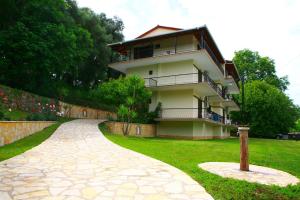 a building with a walkway in front of it at Villa Dimitris in Parga