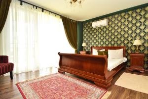 a bedroom with a bed and a rug at Boutique Vila White Duchess in Mamaia Nord