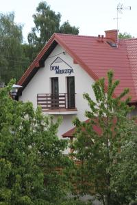 a house with a sign on the side of it at Dom Mierzeja in Kąty Rybackie