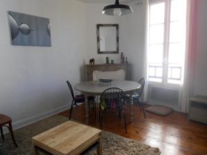 a dining room with a table and chairs at Bakia in Biarritz