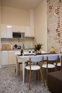 a kitchen with a table and chairs in a room at Zora Apartman in Eger