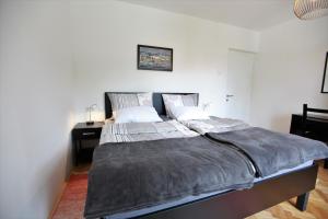a bedroom with a large bed and a desk at Apartment Gondola in Maribor