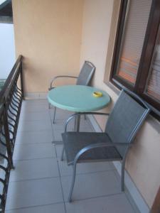 a table and two chairs on a balcony at Bravo Guest House in Bihać