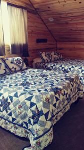 1 dormitorio con 2 camas en una cabaña de madera en Wonder Inn Outback en Panguitch