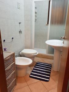 a bathroom with a toilet and a sink at La dimora del capitano in San Vito lo Capo