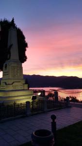 a monument in front of a body of water at sunset at La Casa di Nonna in Pella