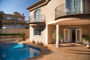 a house with a swimming pool in front of it at MD Villa Cullera Cap Blanc in Faro de Cullera