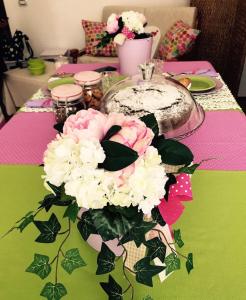 a table with a vase of flowers on a table at up in Carosino