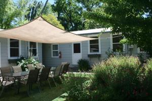 a patio with a table and chairs under a tent at Elm Lodge Bright in Bright