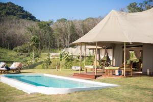 a tent with a swimming pool in a yard at Koyao Island Resort in Ko Yao Noi
