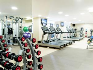 a gym with rows of treadmills and machines at Crown Metropol Perth in Perth