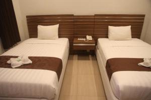 Tempat tidur dalam kamar di Palapa Hotel