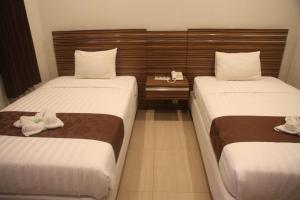 Postel nebo postele na pokoji v ubytování Palapa Hotel