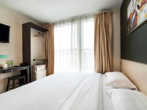 Postel nebo postele na pokoji v ubytování One Avenue Hotel