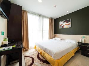 Postel nebo postele na pokoji v ubytování One Avenue Hotel
