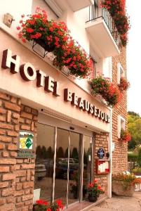 a store with flowers on the front of a building at Hôtel Beauséjour in Chaudes-Aigues