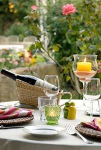 a table with two glasses of wine and a plate at La Terrasse des Oliviers in Mansigné
