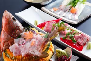 a plate of food with a fish on top of it at Kakimotoya in Sango