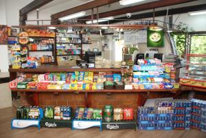 a grocery store with a display of food and drinks at בקתה מקום טוב באמצע in Kinneret