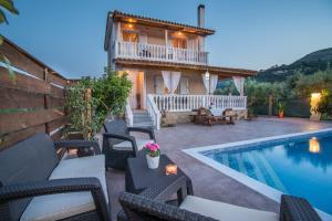 a villa with a swimming pool and a house at Villa Lina in Pandokrátor