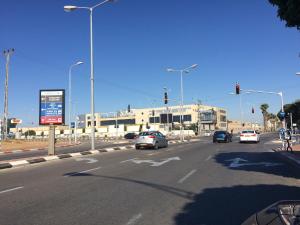 a busy city street with cars stopped at a traffic light at Cozy Jabotinsky Studio in Ashdod in Ashdod