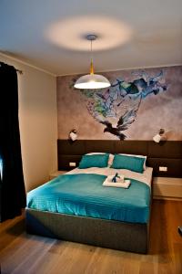 ヤスタルニャにあるWilla Haven BlueApart Jastarniaのベッドルーム1室(壁に絵画が描かれたベッド1台付)