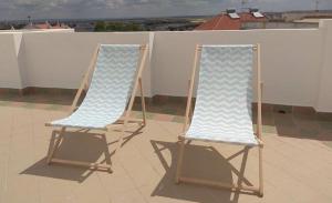 two beach chairs sitting on top of a roof at Casa Maria Victoria in Beja +22 photos