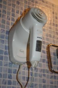 a hair dryer is attached to a wall at Hotel Gabriele in Rome