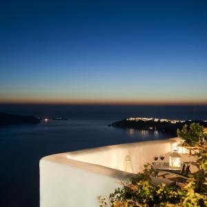 a view of the ocean from a white building at Vallais Villa in Imerovigli