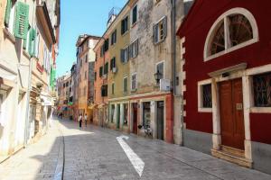 an empty street in a city with buildings at La Prua in Rovinj