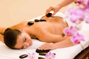 a woman getting a massage in a spa tub at Apollon Boutique Hotel in Parikia