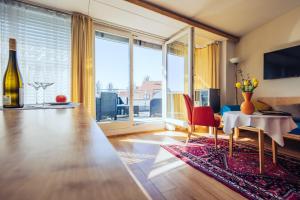 a living room with a table and a large window at Hotel Klinglhuber in Krems an der Donau