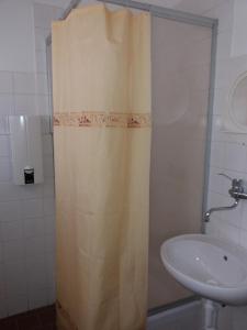 a bathroom with a shower curtain and a sink at Ski & Bike Špičák in Železná Ruda