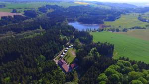 an aerial view of a house in a field and a lake at Resort Blatnice in Františkov